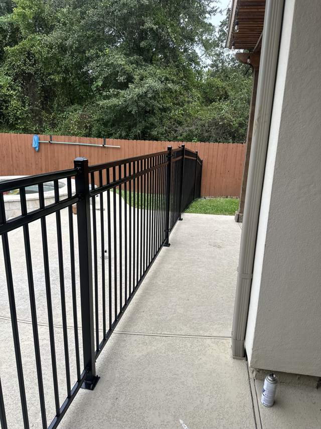 Black metal fence along a walkway