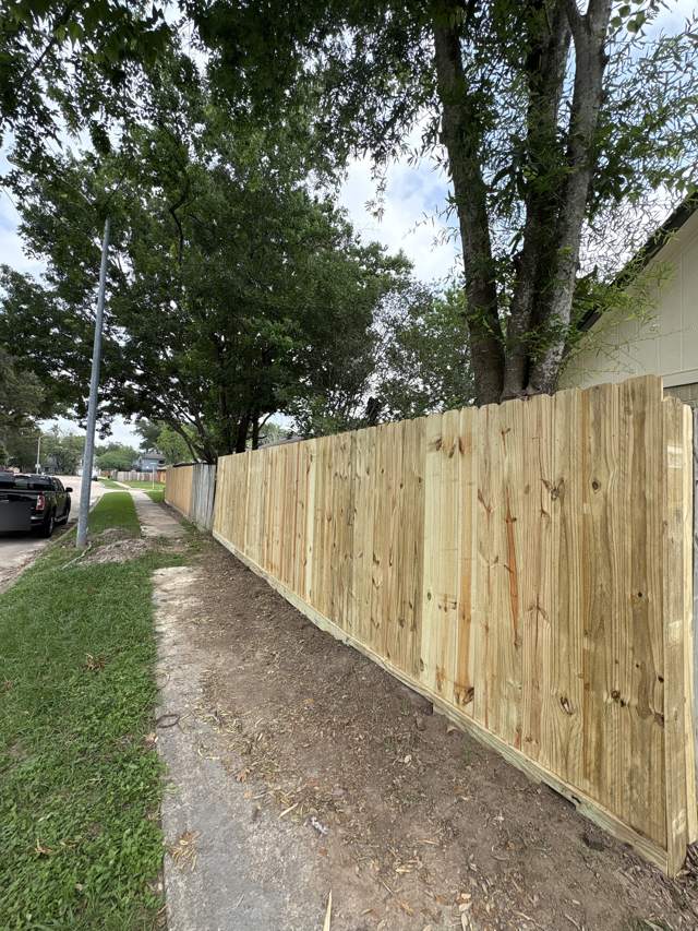 New wood fence along a sidewalk