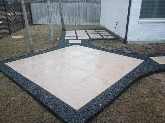 Stone patio with black gravel border
