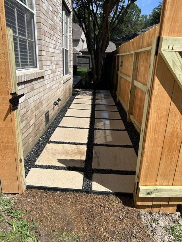 Paver walkway along the side of a house